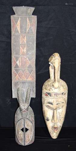 An African wooden Tribal Igbo mask together with another mas...