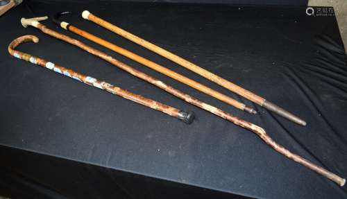 A collection of walking canes including bone & antler handle...