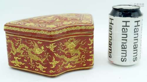 A Chinese porcelain lidded red ground fan shaped box decorat...