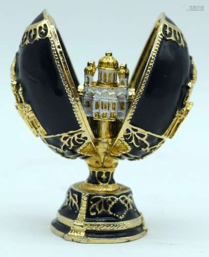 A small carved hardstone egg decorated with gilt metal & ope...