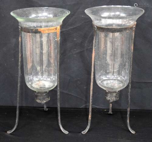 A vintage pair of large glass candle holders in fitted metal...