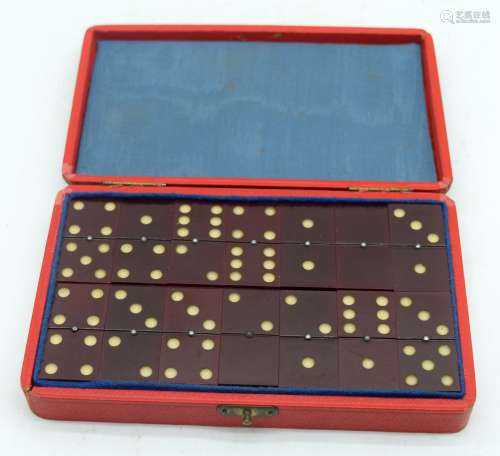 A vintage cased set of Catalin Amber type dominoes 16.5 x 10...
