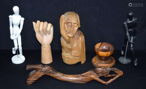 A collection of carved wooden figures and articulated object...