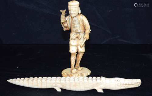 A Japanese ivory figure of a male holding a rat, together wi...