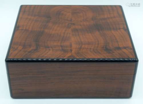 A burled Vavona and Ebony cigar humidor by Elie Bleu contain...