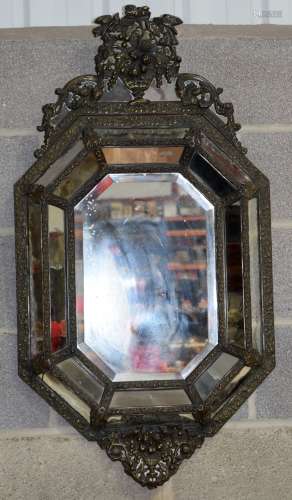 A gilt metal Baroque style mirror . 111 x 58cm.