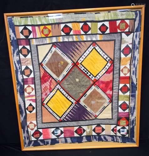 A large framed Middle Eastern textile 98 x 91cm.