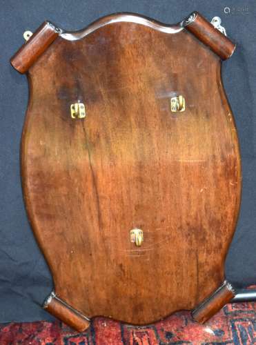An antique Mahogany hanging coat rack decorated with scrolls...