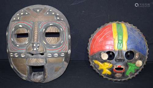 An African tribal mask together with a pottery African mask ...