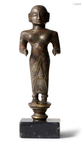 A NORTH INDIAN BRONZE FIGURE OF A FEMALE DEITY OR ATTENDANT ...