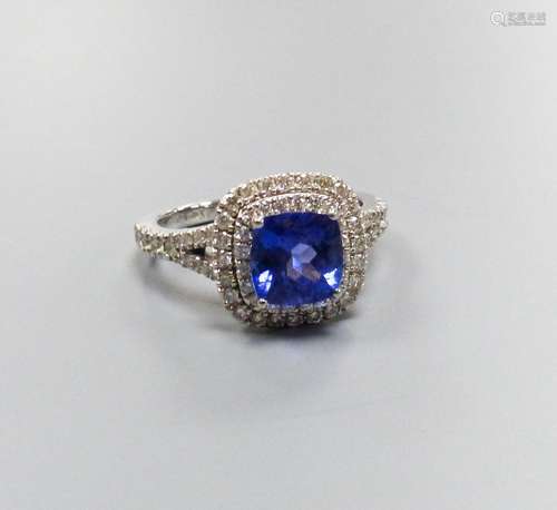 A modern 14k white metal, tanzanite and diamond set square c...