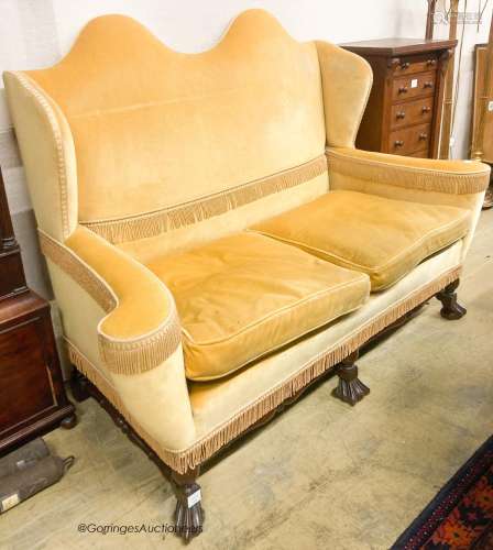 A William and Mary style upholstered wingback settee, length...