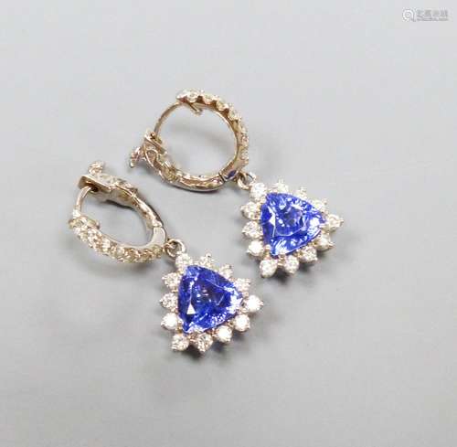 A modern pair of 14k white metal trillion cut tanzanite and ...