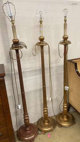 A set of three gilt carved wood lamp standards, height exclu...