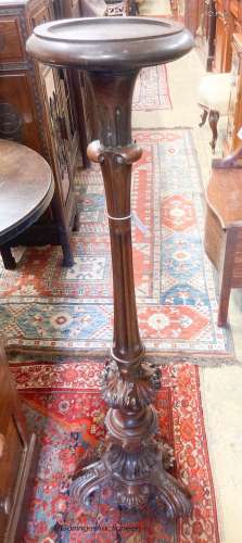 A late Victorian carved mahogany torchere, height 120cm