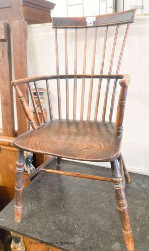 A 19th century elm and fruitwood Windsor comb back armchair,...