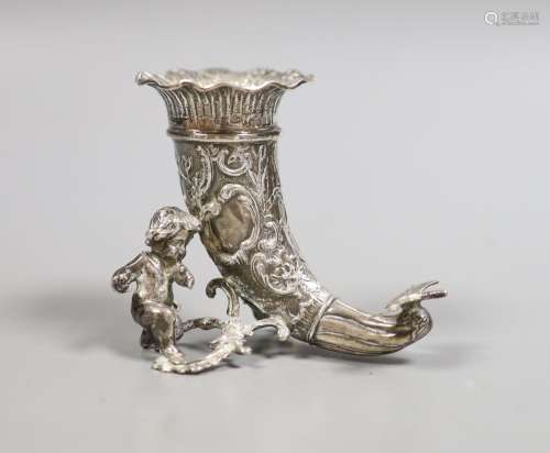 A late Victorian small silver cornucopia vase, with putto su...