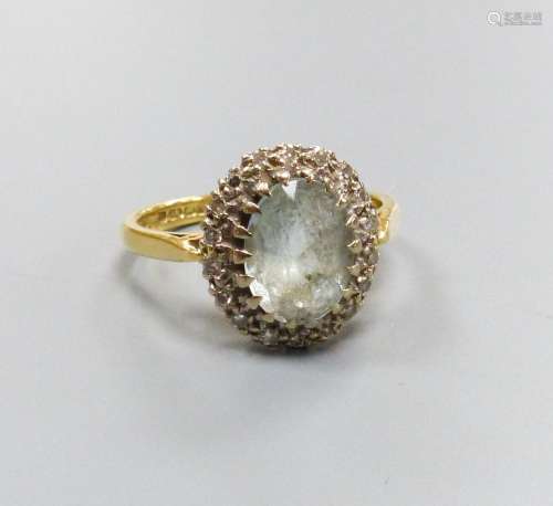 An 18ct gold, aquamarine and diamond cluster ring, size L, g...