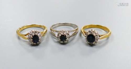 Three modern sapphire and diamond set oval cluster rings, in...