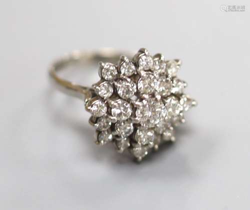 A modern 18ct white gold and diamond set flower head cluster...