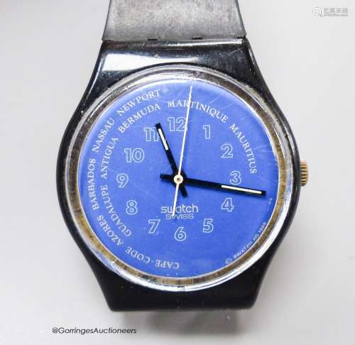 A Swatch watch (strap a.f.).
