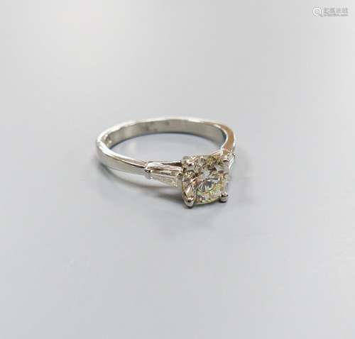 A modern platinum and single stone diamond ring, with trapez...