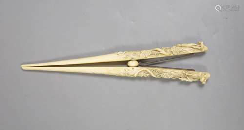 A pair of late 19th century carved ivory glove stretchers