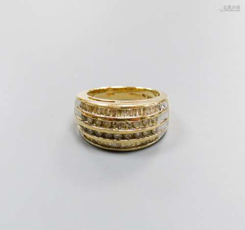 A modern 9ct gold and four row round and baguette cut diamon...