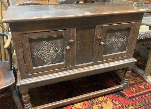 A Tudor style oak two door cupboard, enclosed by two doors, ...