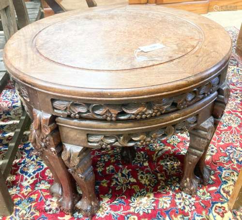 A Chinese circular carved hardwood circular low table with a...
