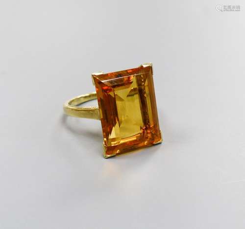 A modern yellow metal and emerald cut citrine set dress ring...