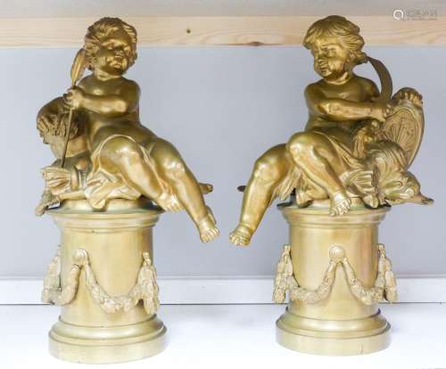 A pair of bronze figures of Cupid on circular pedestals, ear...