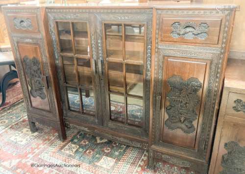 A Chinese carved hardwood breakfront display cabinet, glazed...