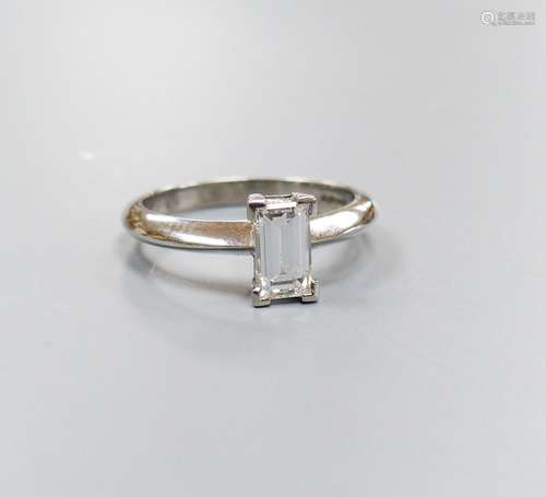 A modern platinum and solitaire rectangular cut diamond ring...