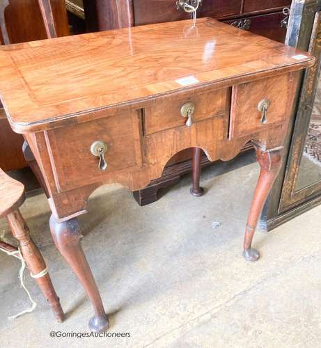 An early 18th century feather banded walnut three drawer low...