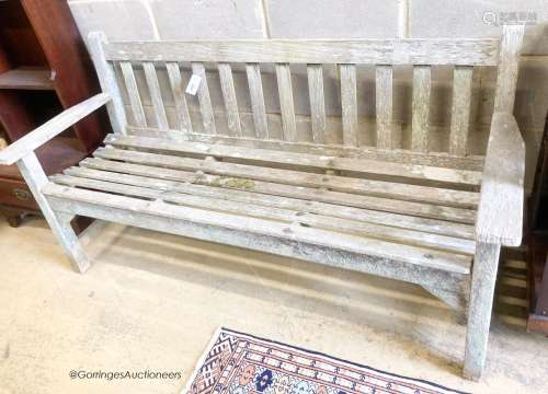 A weathered teak garden bench, length 159cm, depth 56cm, hei...