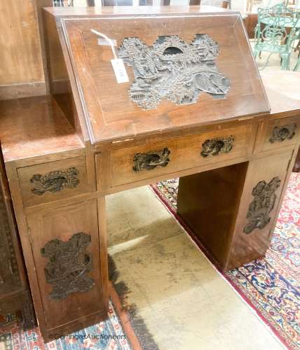 A 20th century Chinese carved hardwood bureau fitted with th...