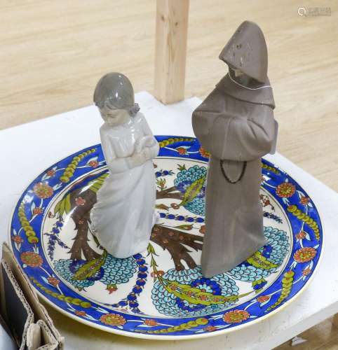 A Lladro figure of a monk, a Nao figure of a girl and an Isn...