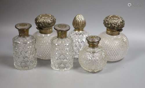 Six assorted silver topped glass scent bottles, including a ...