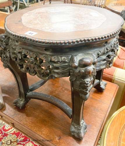 A Chinese carved hardwood jardiniere stand with rouge marble...