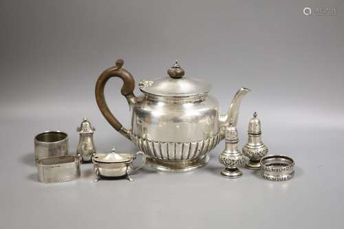 A late Victorian silver teapot, of circular half-fluted pede...