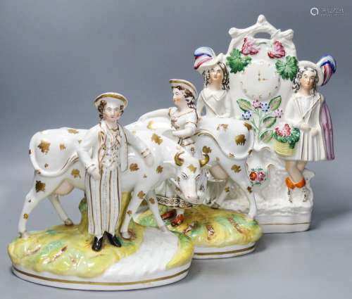 A pair of 19th century Staffordshire cow groups and a simila...