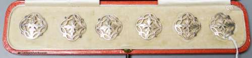 An Edwardian cased set of six pierced silver dress buttons, ...