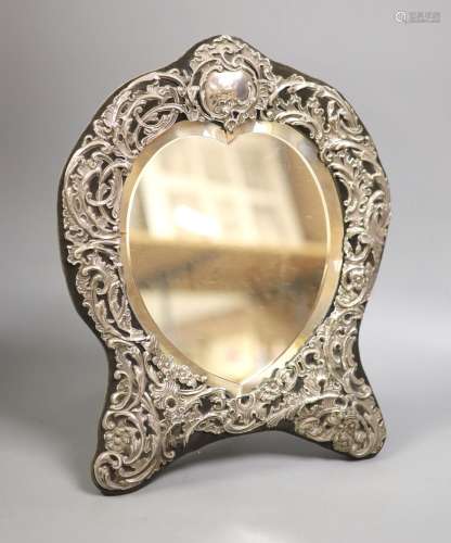 An Edwardian repousse silver mounted easel mirror, with hear...