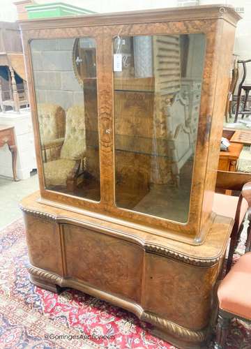 A 1930's walnut veneered china display cabinet combined cupb...