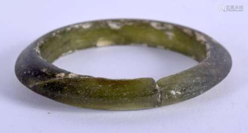 A VERY RARE CHINESE DARK GREEN GLASS BANGLE Tang Dynasty, of...