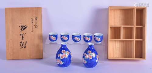 A JAPANESE TAISHO PERIOD PORCELAIN SAKE SET painted with flo...