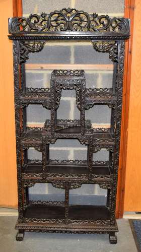 A 19TH CENTURY CHINESE CARVED HARDWOOD HONGMU DISPLAY CABINE...