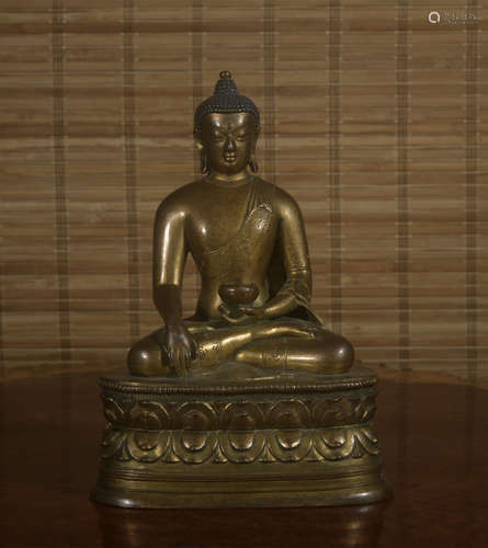 A gilt-bronze statue of Pharmacist Buddha