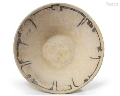 A NISHAPUR CALLIGRAPHIC SLIP-PAINTED POTTERY BOWL, PERSIA, 1...